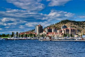 Kelowna BC downtown waterfront with Okanagan Lake and mountains - is Kelowna worth visiting